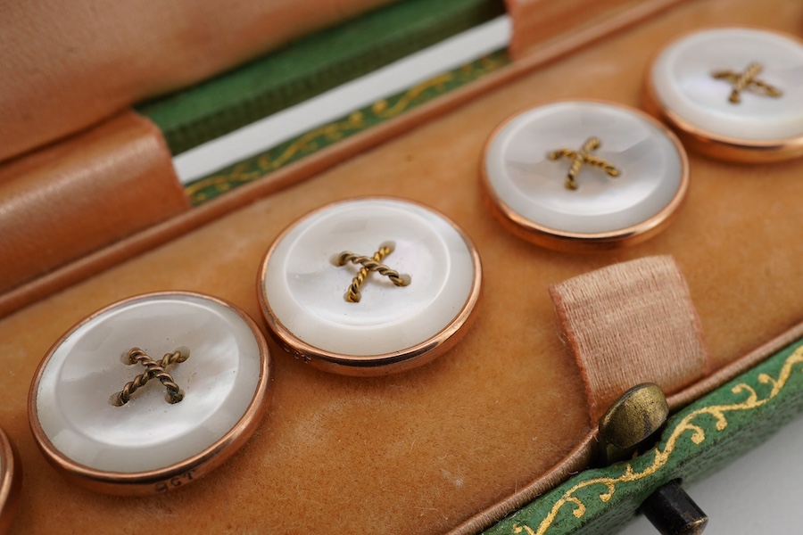 A set of six 9ct mounted mother of pearl dress studs, in a fitted gilt tooled leather case. Condition - fair to good